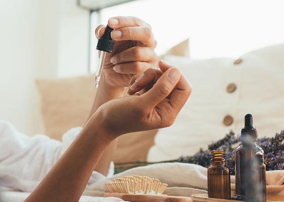 lady dropping essential oils on her skin