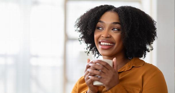 Lady holding cup of tea and talking